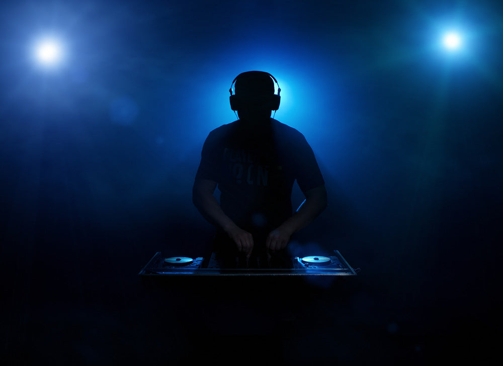 DJ silhouette backlit.